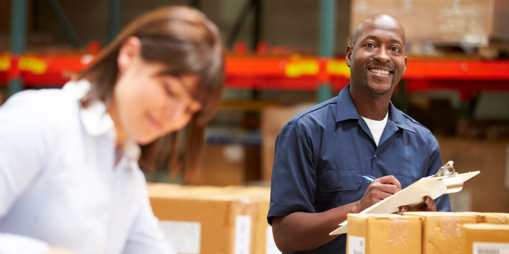 coworkers in a warehouse working happily together